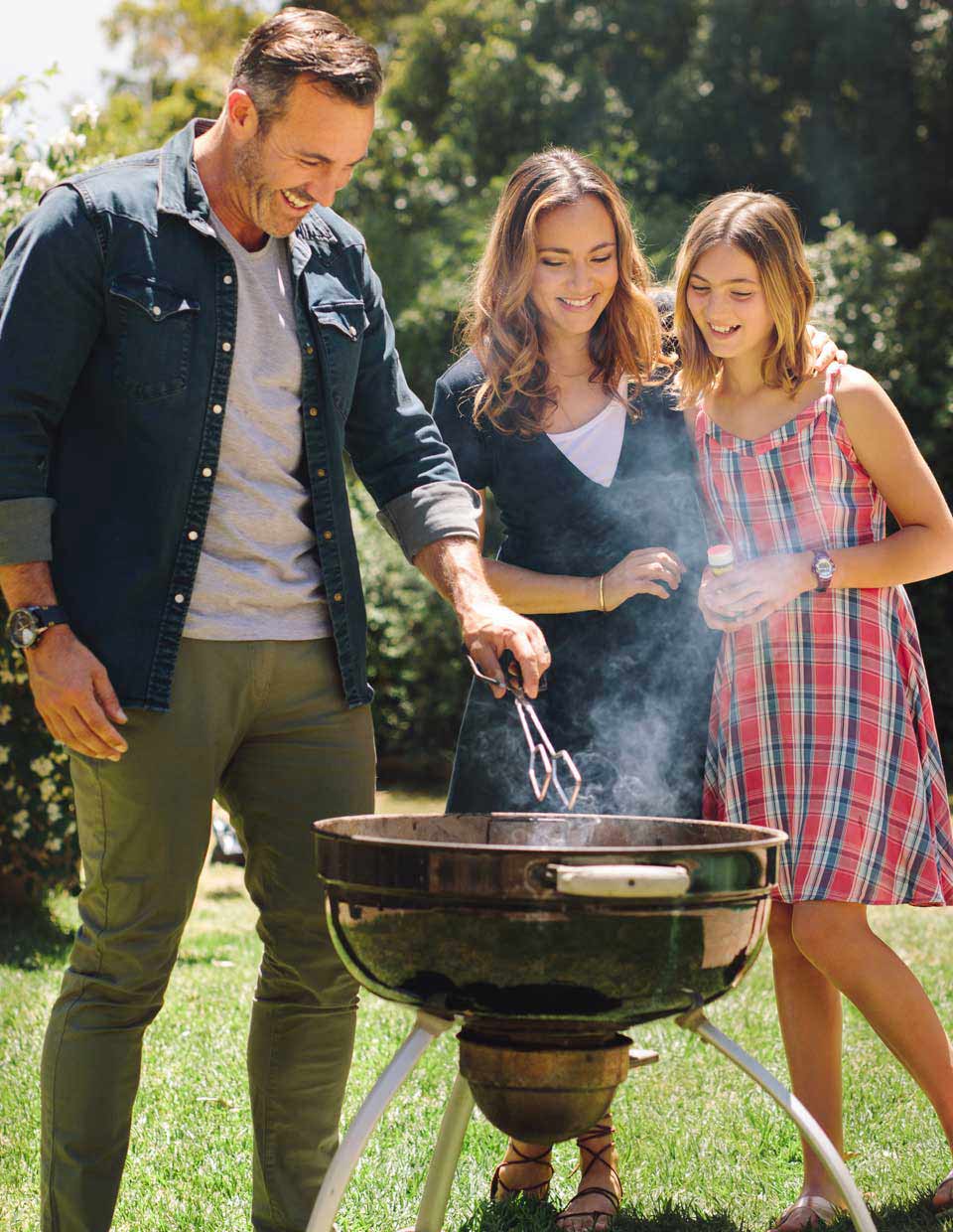 promo image for family barbequing in their backyard